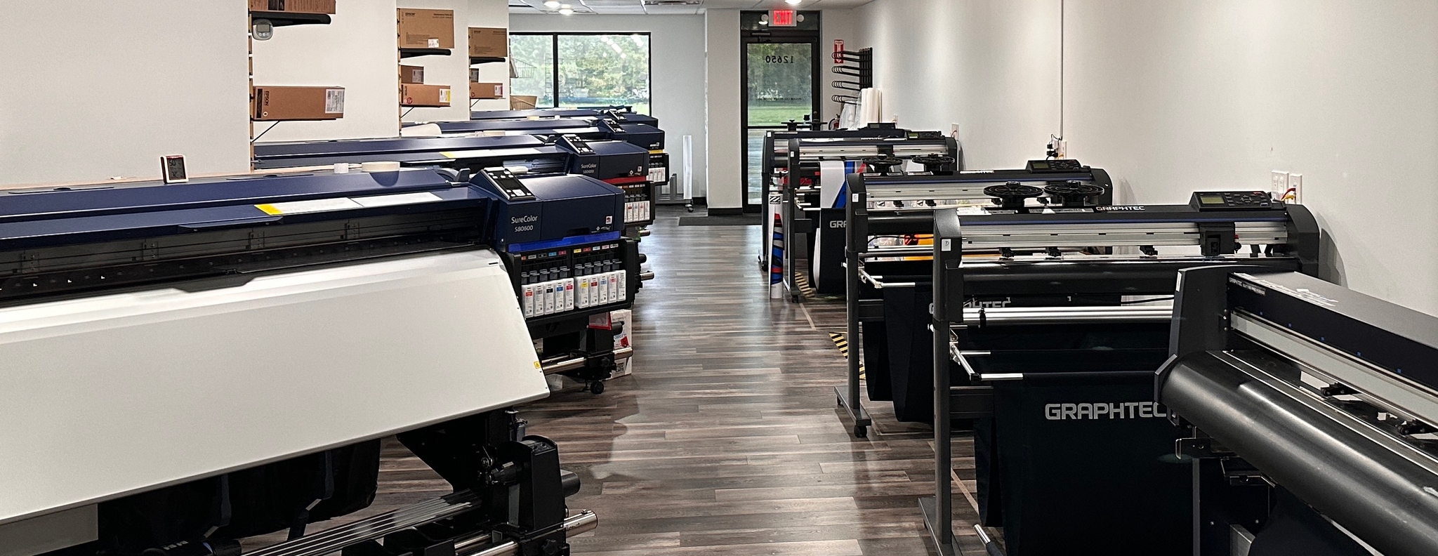 The ArcticFX print area with several printers and cutters for snowmobile wrap production